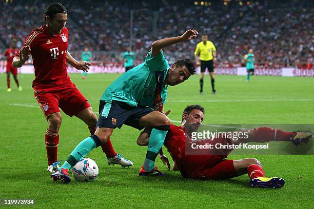 Danijel Pranjic of Bayern and Diego Contento of Bayern challenge David Villa of Barcelona during the Audi Cup final match between FC Bayern Muenchen...