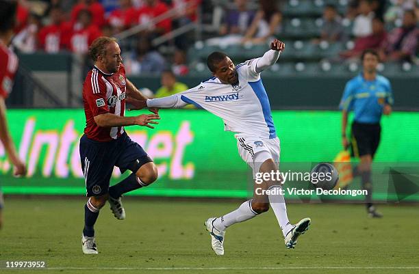 Ryan Johnson of the San Jose Earthquakes wins position to the ball past Simon Elliott of Chivas USA during their MLS game at The Home Depot Center on...