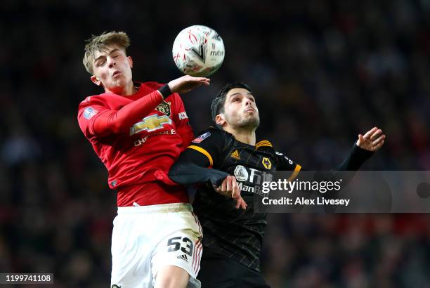 Brandon Williams of Manchester United heads the ball away from Pedro Neto of Wolverhampton Wanderers during the FA Cup Third Round Replay match...