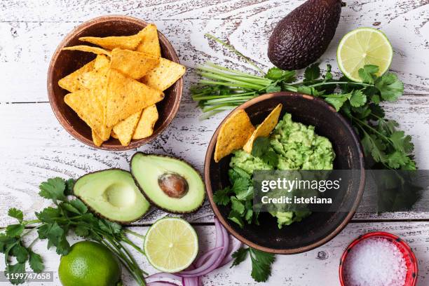 making guacamole sauce, mexican cuisine ingredients - guacamole stock-fotos und bilder