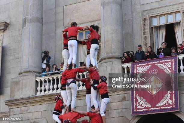 Castellers form a castel, a human tower, seen during the Santa Elulalia festival in Barcelona. These human towers are built traditionally during the...