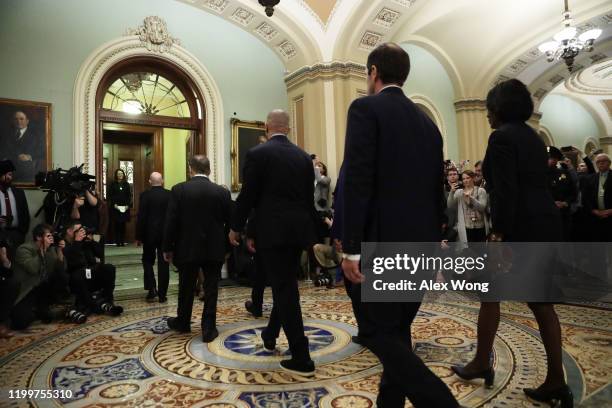 House Sergeant at Arms Paul Irving and House clerk Cheryl Johnson hold the two impeachment articles as they lead the seven impeachment managers,...