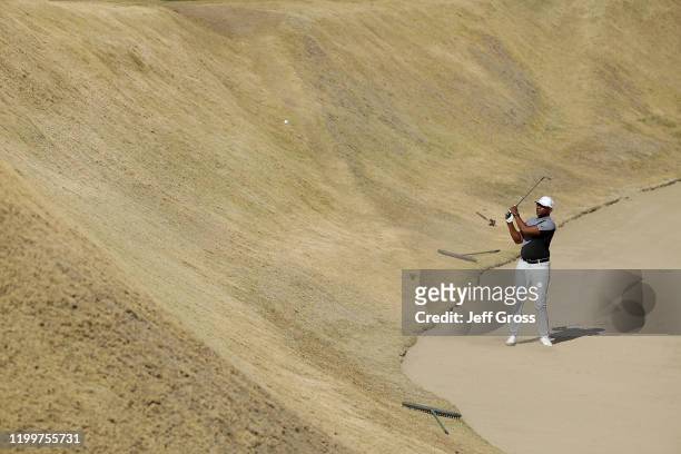 Former NFL player and Hall of Famer Eric Dickerson plays a bunker shot on the 16th hole during the American Express Bob Hope Legacy Pro-Am on the...