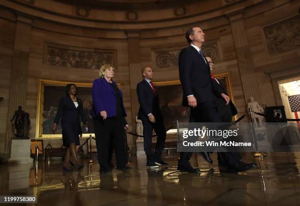 House managers accompany the articles of Impeachment against U.S. President Donald Trump as they are carried through the Rotunda of the U.S. Capitol...