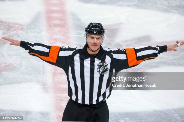 Referee Dean Morton waves off a Winnipeg Jets goal following a Vancouver Canucks coaches challenge during first period action at Bell MTS Place on...