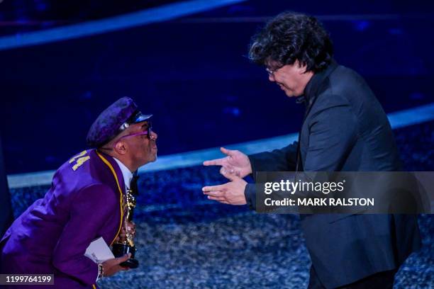 South Korean film director Bong Joon Ho accepts the award for Best Director for "Parasite" from US director Spike Lee during the 92nd Oscars at the...