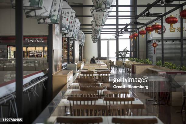 Single passenger sits in a food outlet in the departure hall of Hongqiao Highspeed Railway Station in Shanghai, China on Sunday, Feb. 9, 2020. Most...