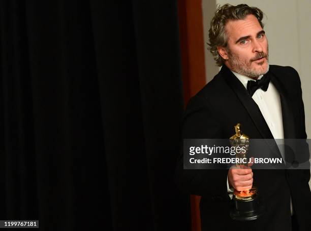 Actor Joaquin Phoenix poses in the press room with the Oscar for Best Actor for "Joker" during the 92nd Oscars at the Dolby Theater in Hollywood,...