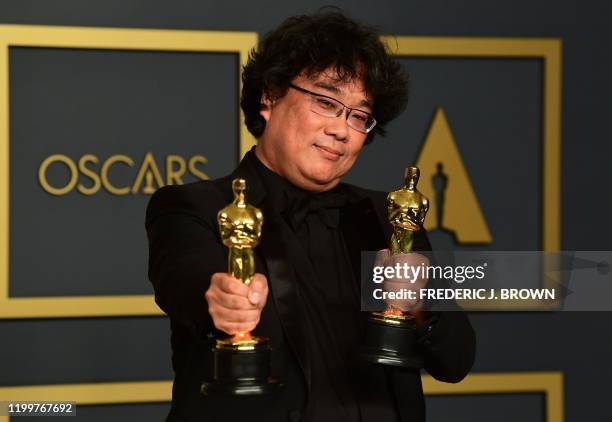 South Korean director Bong Joon-ho poses in the press room with the Oscars for "Parasite" during the 92nd Oscars at the Dolby Theater in Hollywood,...