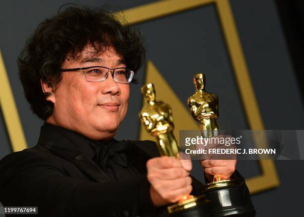 South Korean director Bong Joon-ho poses in the press room with the Oscars for "Parasite" during the 92nd Oscars at the Dolby Theater in Hollywood,...