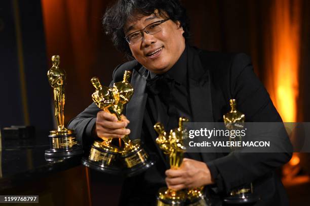 South Korean film director Bong Joon Ho poses with his engraved awards as he attends the 92nd Oscars Governors Ball at the Hollywood & Highland...