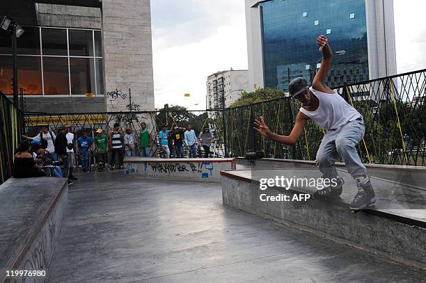 Boy performs a railtrick on his rollerblades at a public skatepark in Caracas, on July 27, 2011. AFP PHOTO / Leo RAMIREZ