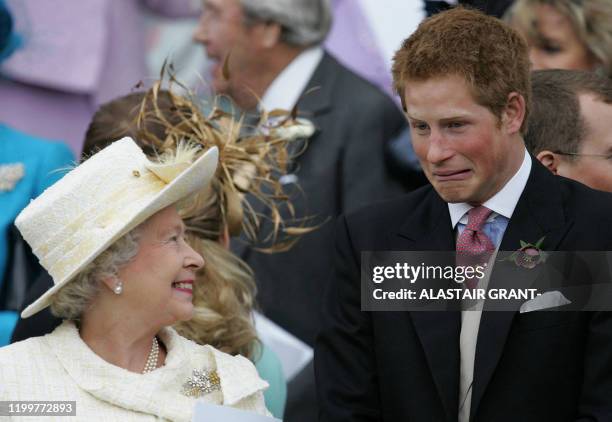 Britain's Queen Elizabeth II and Prince Harry share a joke as they watch Prince Charles and his bride Camilla Duchess of Cornwall leave St George's...