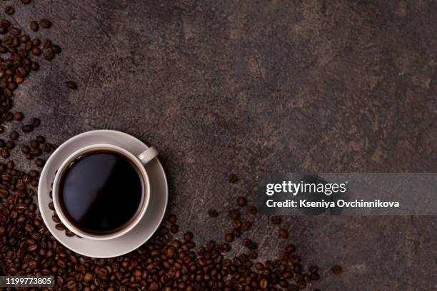 coffee cup and coffee beans on wooden background. top view. - coffee cup top view stock pictures, royalty-free photos & images