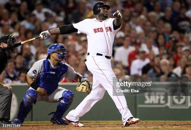 David Ortiz of the Boston Red Sox hits a grand slam in the fourth inning as Brayan Pena of the Kansas City Royals catches on July 27, 2011 at Fenway...