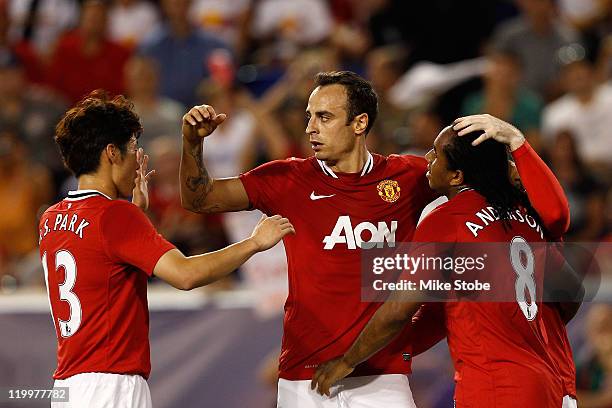 Dimitar Berbatov, Ji-Sung Park and Anderson of the Manchester United celebrate Anderson's goal in the twentieth minute against the MLS All-Stars...