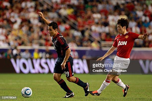 Omar Bravo of the MLS All-Stars controls the ball against Ji-Sung Park of the Manchester United during the first half of the MLS All-Star Game at Red...