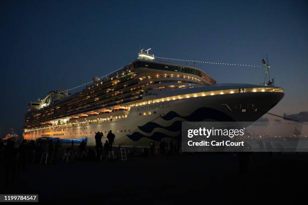 Members of the media work next to the Diamond Princess cruise ship at Daikoku Pier where it is being resupplied and newly diagnosed coronavirus cases...