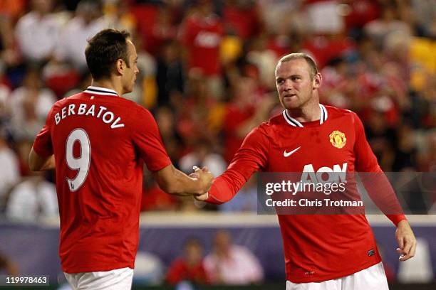 Wayne Rooney of the Manchester United congratulates teammate Dimitar Berbatov on his goal against the MLS All-Stars during the second half of the MLS...