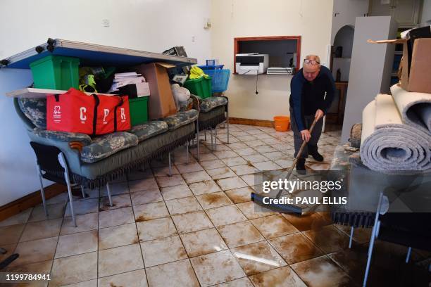 Man cleans up inside the Appleby and District Community First Responder Group meeting room in Appleby, northwest England, on February 10, 2020 after...