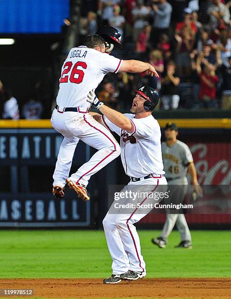 David Ross of the Atlanta Braves celebrates with Dan Uggla after knocking in the game-winning run in the 10th inning against the Pittsburgh Pirates...