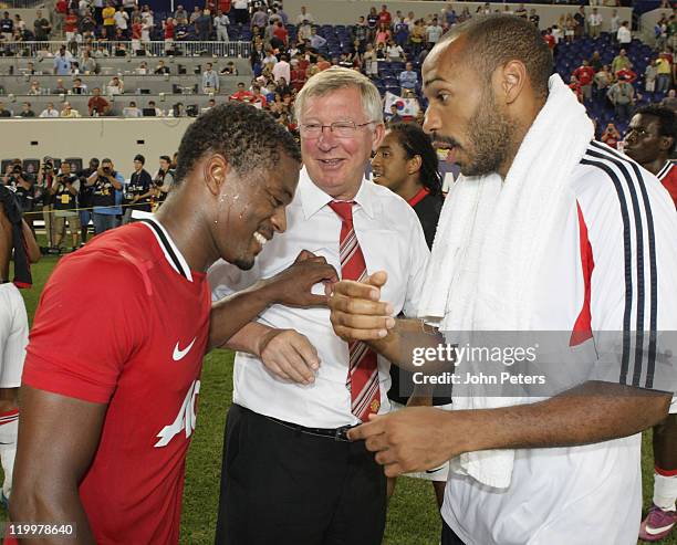 Patrice Evra and Sir Alex Ferguson of Manchester United talk to Thierry Henry of MLS All Stars after the MLS All Star match between MLS All Stars and...