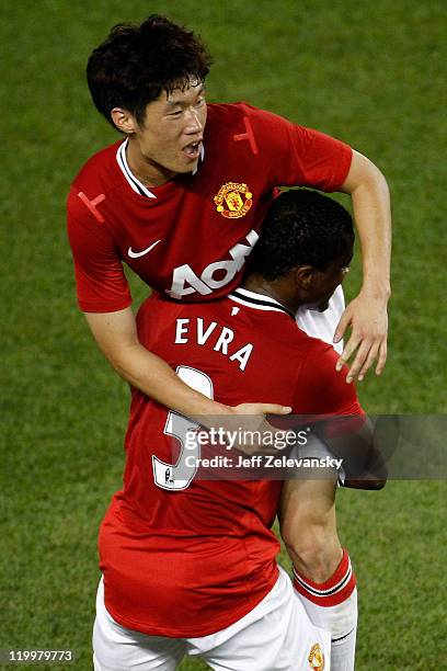 Ji-Sung Park of the Manchester United celebrates his goal in the forty-fifth minute with teammate Patrice Evra against the MLS All-Stars during the...