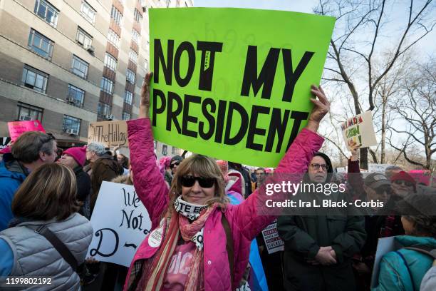 Marchers holds a sign that say, "Not My President " walking during the second annual Women's March in the borough of Manhattan in New York City, U.S....