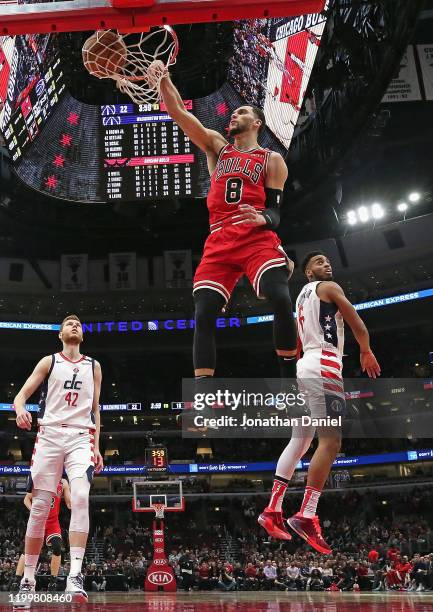 Zach LaVine of the Chicago Bulls dunks over Davis Bertans and Troy Brown Jr. #6 of the Washington Wizards on his way to a game-high 30 points at the...