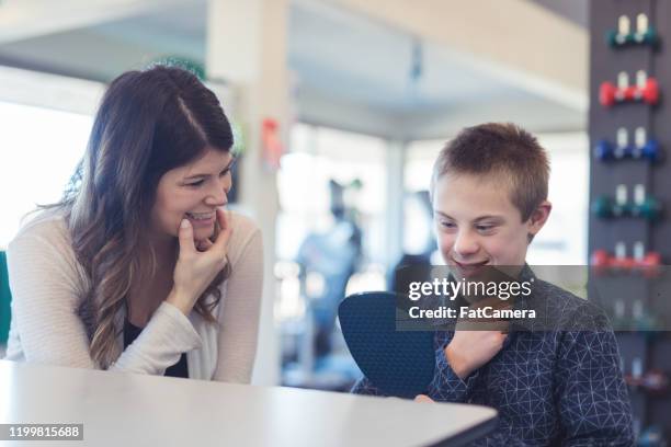 speech therapist works with a young boy - speech therapy imagens e fotografias de stock