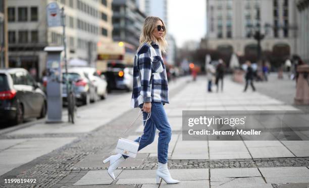 Scarlett Gartmann wearing Gianvitto Rossi boots, Mango Jeans, H&M jacket, Chanel bag and Saint Laurent shirt during the Berlin Fashion Week...
