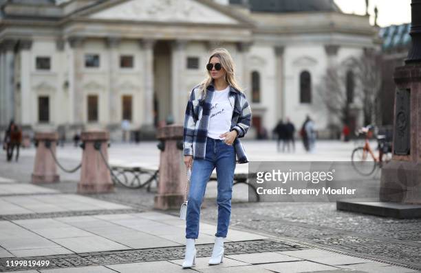Scarlett Gartmann wearing Gianvitto Rossi boots, Mango Jeans, H&M jacket, Chanel bag and Saint Laurent shirt during the Berlin Fashion Week...