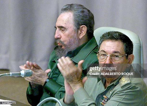 Cuban President Fidel Castro and his brother and Armed Forces Minister Raul Castro applaud during the parliamentary session of the Cuban government...