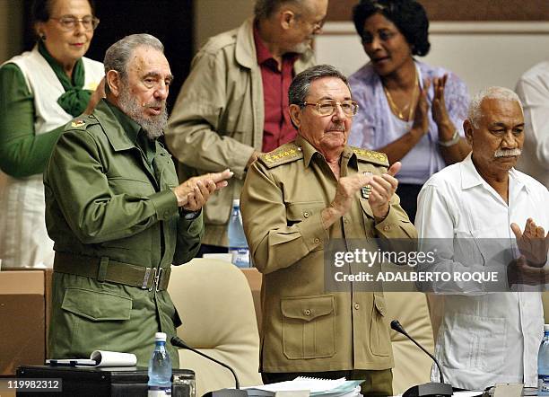 Cuban President Fidel Castro and his brother and Minister of the Armed Forces, General Raul Castro , applaud 25 June 2002 in Havana, Cuba during a...