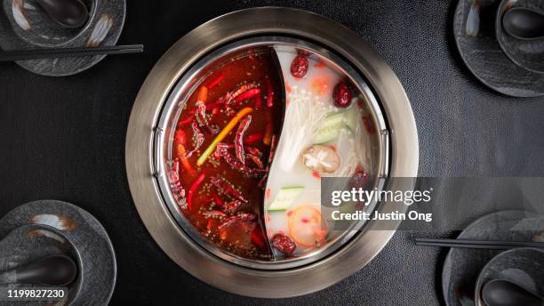 traditional hotpot soup with ingredients - hot pots stockfoto's en -beelden