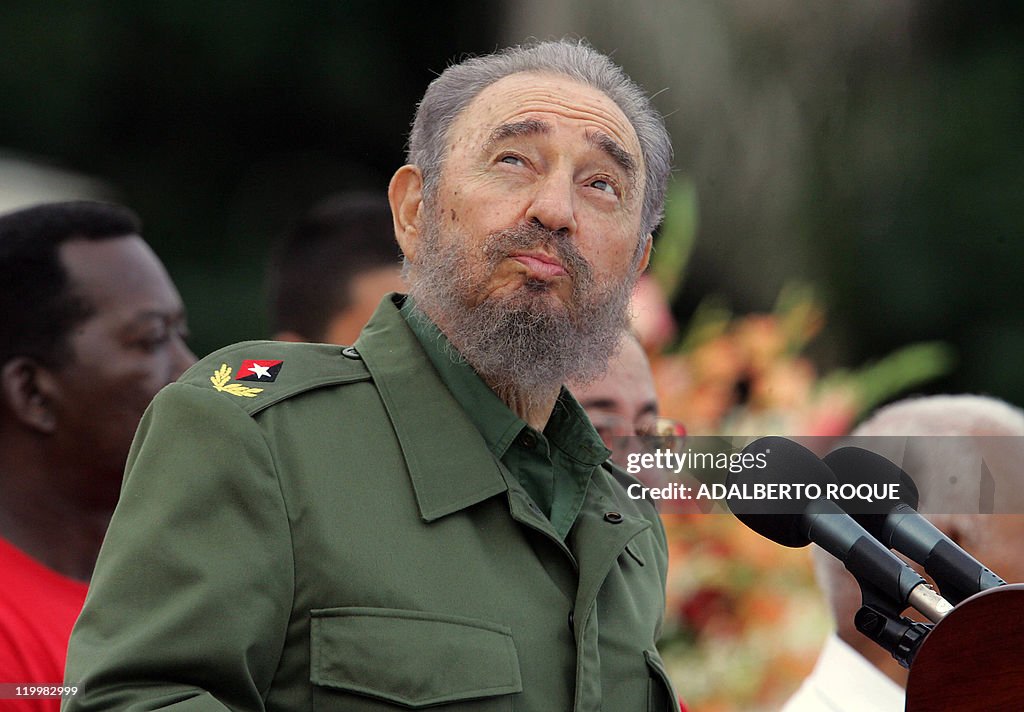 Cuban President Fidel Castro checks the