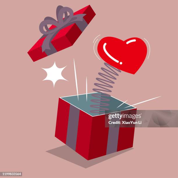 pop-up gift box with heart symbol. isolated on brown background. - coiled-spring stock illustrations