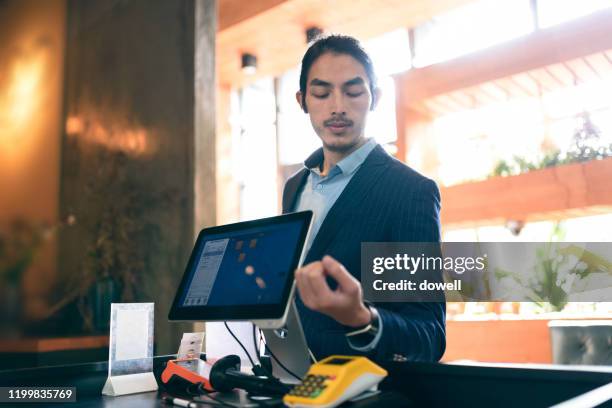 young asian businessman contactless payment with smart watch in restaurant - smartwatch pay stock pictures, royalty-free photos & images