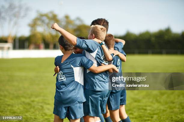 young spanish boy footballers celebrating triumph - blue shirt back stock pictures, royalty-free photos & images