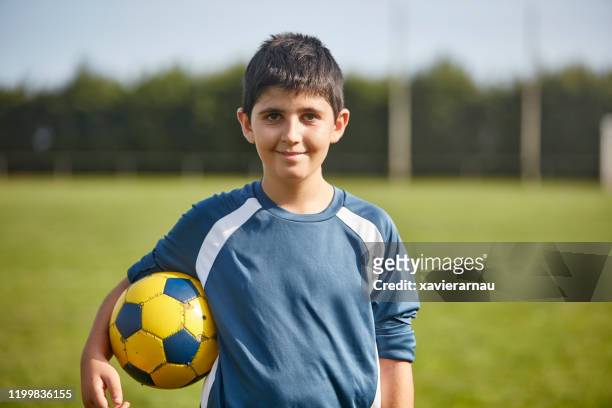 portrait of preteen spanish male footballer on sports field - thirteen years old stock pictures, royalty-free photos & images