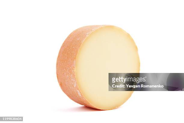 monk's head cheese wheel isolated on white background - käse stock-fotos und bilder