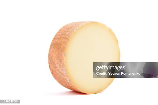 monk's head cheese wheel isolated on white background - gouda round foto e immagini stock