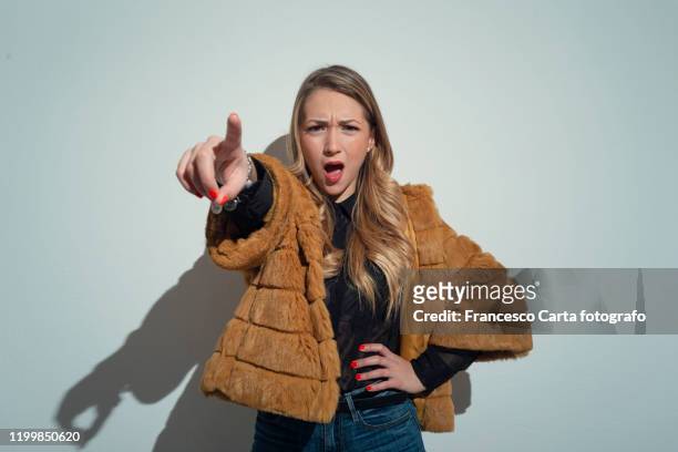 woman pointing to camera somewhat angry - rich fury stock pictures, royalty-free photos & images