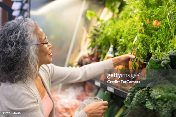 senior woman grocery shopping - pacific islanders stock pictures, royalty-free photos & images