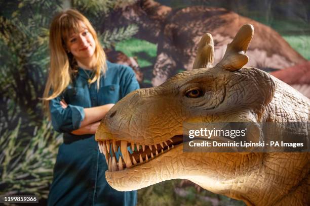 Exhibitions officer Kerstin Doble views an animatronic model of a Estemmenosuchus, during the preview for the Horniman Museum's 'Permian Monsters:...