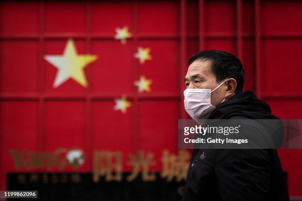 Man wears a protective mask on February 10, 2020 in Wuhan, China. Flights, trains and public transport including buses, subway and ferry services...