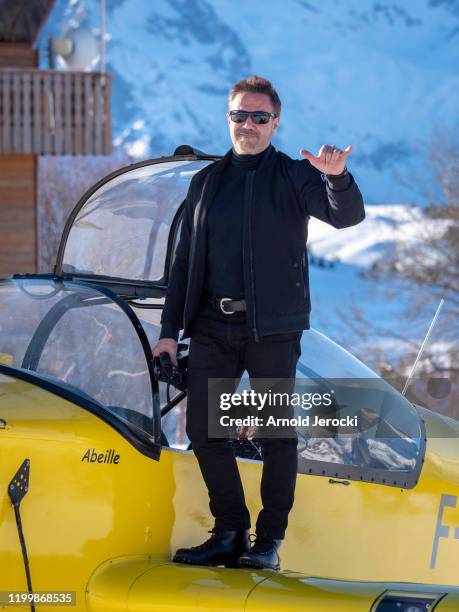 Jose Garcia poses after a flight at the alpine altiport during the third day of the 23rd L'Alpe D'Huez International Comedy Film festival on January...