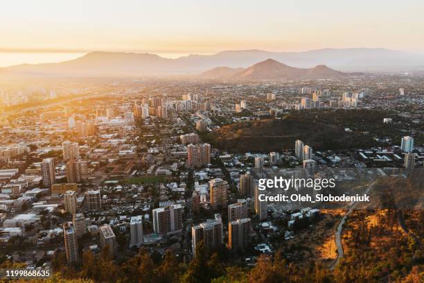 scenic view of santiago at sunset in summer from above - santiago chile sunset stock pictures, royalty-free photos & images