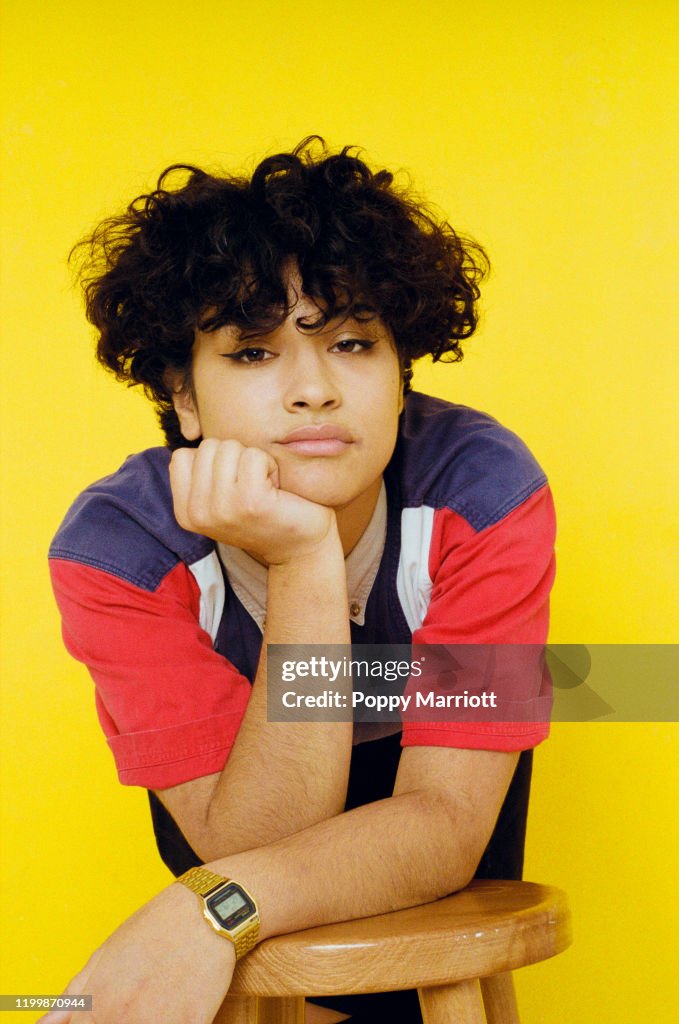 Colourful studio portrait of a young non-binary individual