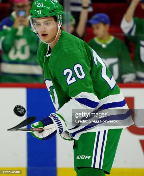 Sebastian Aho of the Carolina Hurricanes juggles the puck during an NHL game against the Los Angeles Kings on January 11, 2020 at PNC Arena in...